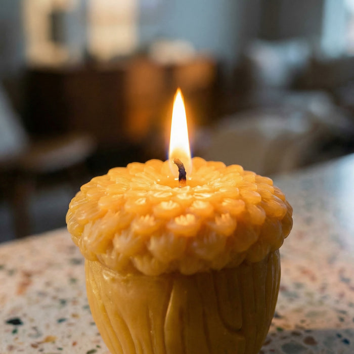 Lit Raw Acorn shaped candle on tabletop