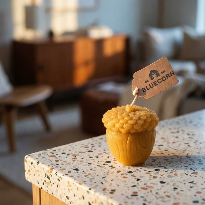 Raw Acorn shaped candle with Bluecorn tag with coffee shop background