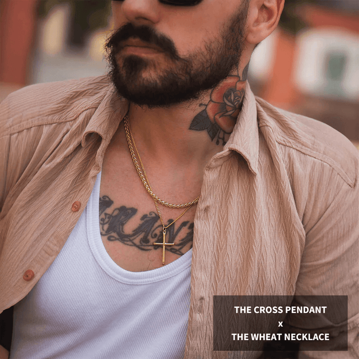 Build Your Own Bundle - Gold featuring a bold gold cross pendant layered with a textured gold wheat necklace, styled on a man with tattoos and a beige open shirt, bold by design.