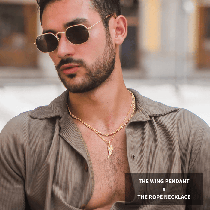 Man wearing gold-tone Build Your Own Bundle - Gold featuring a bold wing pendant necklace paired with a twisted rope chain, styled with sunglasses and an open collar shirt.
