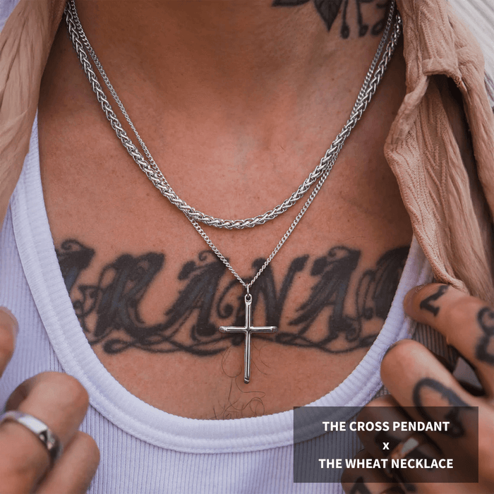 Build Your Own Bundle - Silver features a men's bold silver cross pendant paired with a textured silver wheat chain necklace, styled over a white tank top with tattoos visible.
