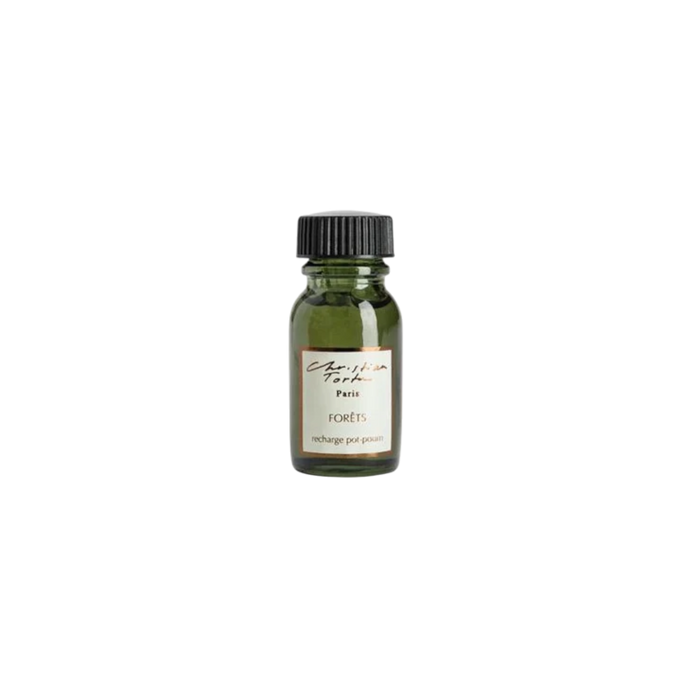 Christian Tortu Potpourri Refresher Oil - A small dark green glass bottle with a black ribbed cap and a cream label reading 'Christian Tortu' and 'forets', shown on a plain white background.