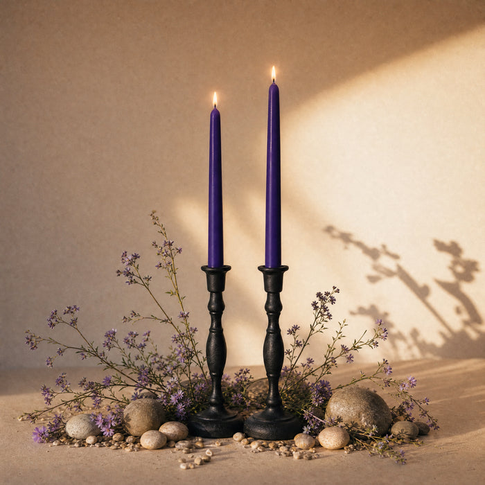 dark purple beeswax taper candles in cast iron candle holders