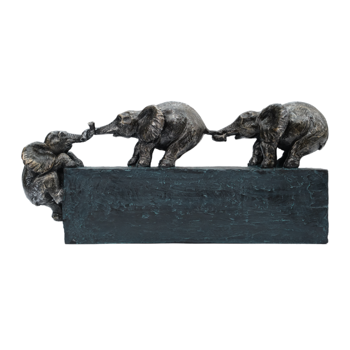 Bronze sculpture of three elephants on a black base