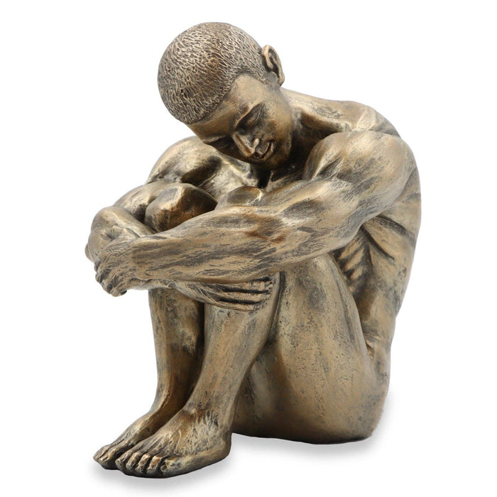 Bronze statue of a man holding a child on a white background