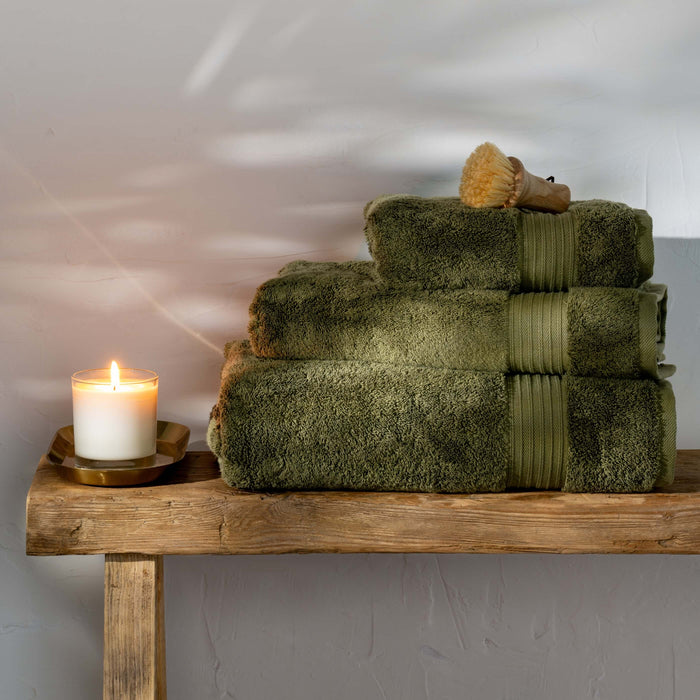 Olive Green Egyptian Cotton Hand Towels styled in a bedroom | Soak and Sleep