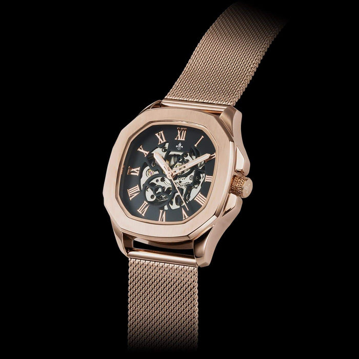 Luxury men's statement watch featuring a rose gold case with Roman numeral markers, a black skeleton dial, and a Rose Gold Mesh Interchangeable Strap, bold by design.