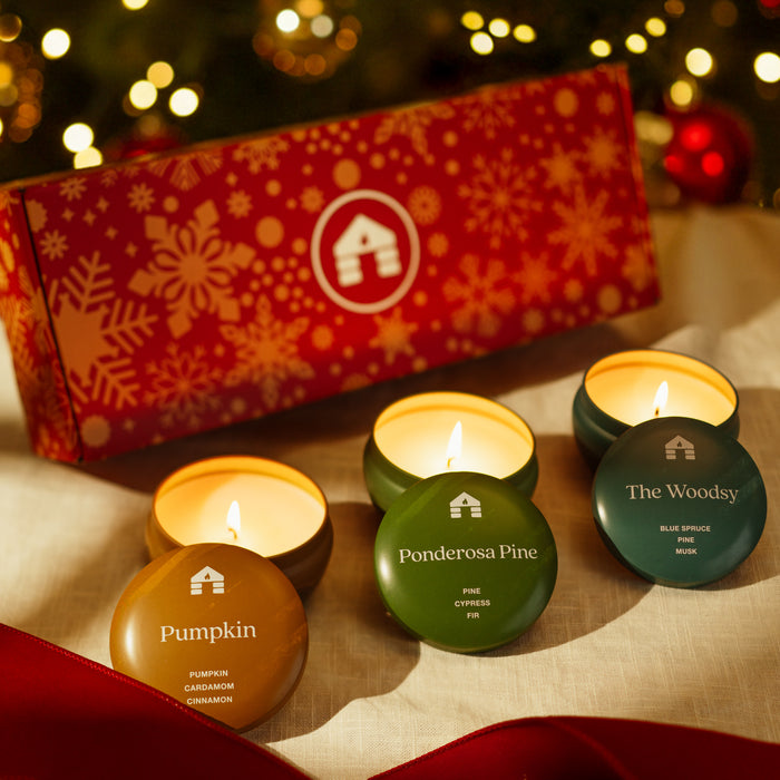Scented candle gift set with three 8oz tins: Pumpkin, Ponderosa Pine, and The Woodsy, beautifully presented in a festive box.