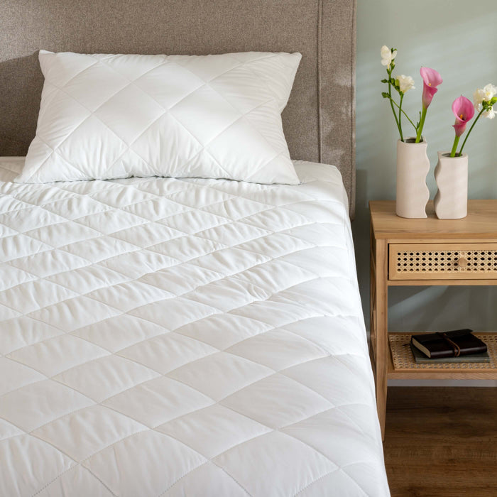 Soft Touch Mattress Protectors styled in a bedroom | Soak and Sleep