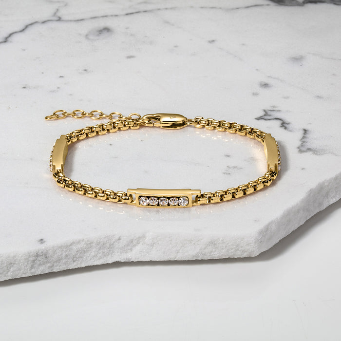The Atlas Ice Bracelet, a men's luxury gold bracelet featuring a sleek chain and a central bar set with sparkling cubic zirconia stones, designed to be noticed with bold style.