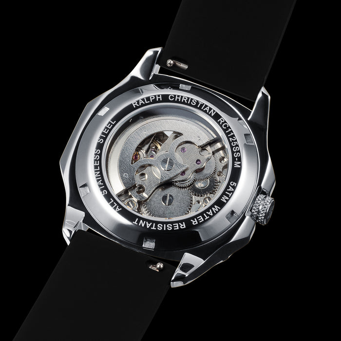 The Avalon - Silver men's luxury watch showcasing a polished silver stainless steel case, exhibition case-back revealing intricate movement details, and a sleek black strap.