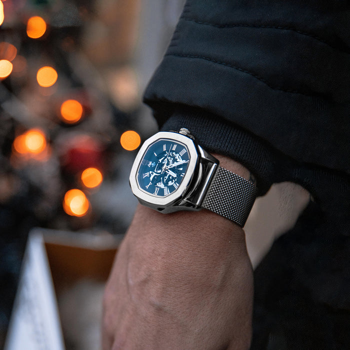 The Avalon - Silver men's luxury watch with a polished silver case, blue dial featuring chronograph subdials, and a stainless steel mesh bracelet, bold by design.