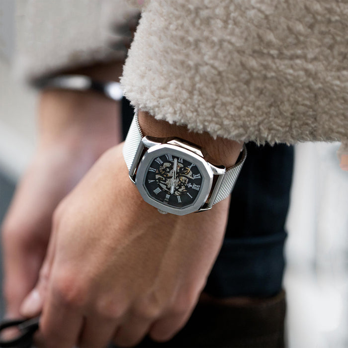The Avalon - Silver men's luxury watch featuring a silver mesh strap, a bold octagonal case, and a detailed black dial with chronograph subdials and sapphire-coated crystal, worn on wrist.