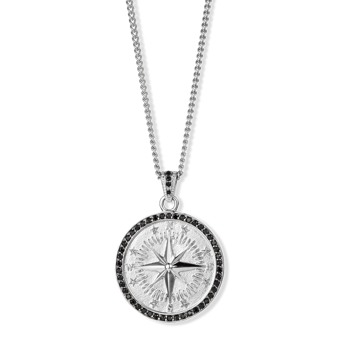 The Compass Essentials Bundle - Silver features a bold men's pendant necklace with a detailed compass design in silver and a black stone-studded border, suspended from a matching silver chain.