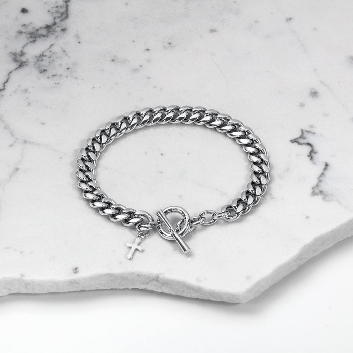The Cross Pendant Bracelet - Silver features a bold, polished silver chain with a toggle clasp and a small cross pendant, embodying Ralph Christian’s luxury jewelry crafted to be noticed.