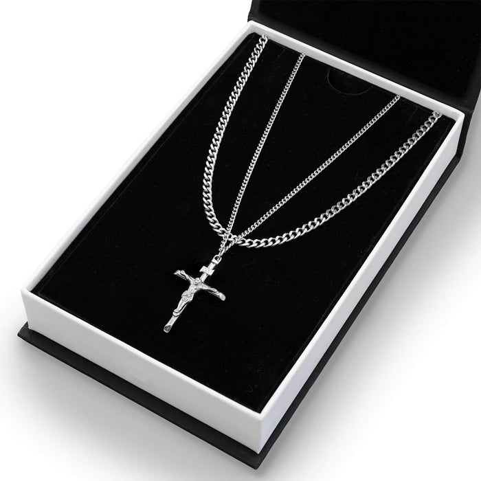 The Crucifix Essentials Bundle - Silver featuring two polished silver chains, one with a detailed crucifix pendant, presented in a sleek black and white display box.