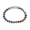 The Damascus Voyage Bracelet features alternating polished blue and brown stone beads with sleek silver-toned metal accents and a secure clasp, designed to be noticed. Bold by Design.