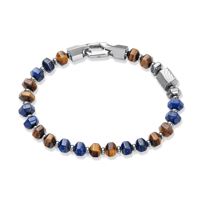 The Damascus Voyage Bracelet features alternating polished blue and brown stone beads with sleek silver-toned metal accents and a secure clasp, designed to be noticed. Bold by Design.