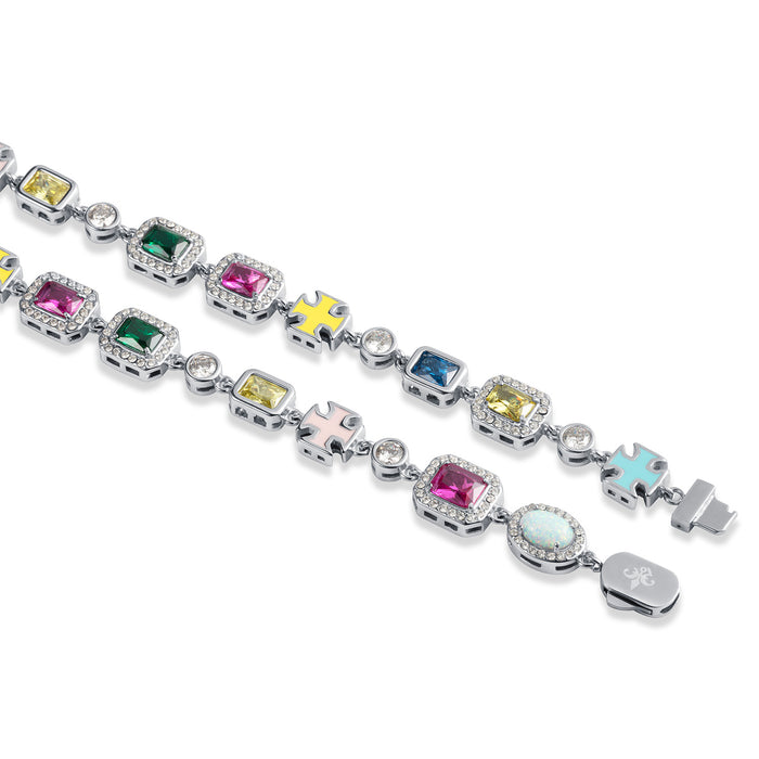 Close-up of The Gemstone Bracelet featuring vibrant, multi-colored stones set in polished silver links, accented with pastel enamel crosses, showcasing bold luxury jewelry designed to be noticed.