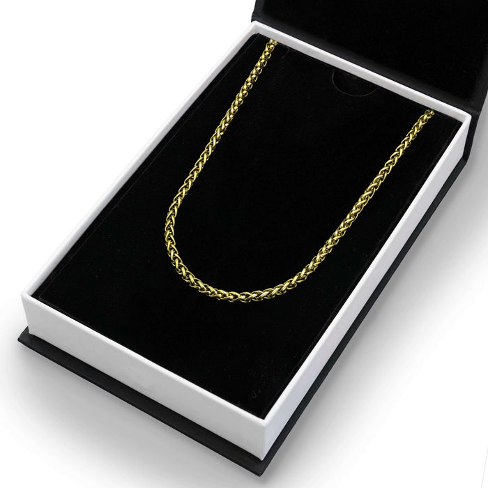 The Gold Wheat Necklace - Essentials Collection in gold-tone metal displayed in a black velvet-lined luxury gift box, showcasing men's jewelry with bold, standout design.