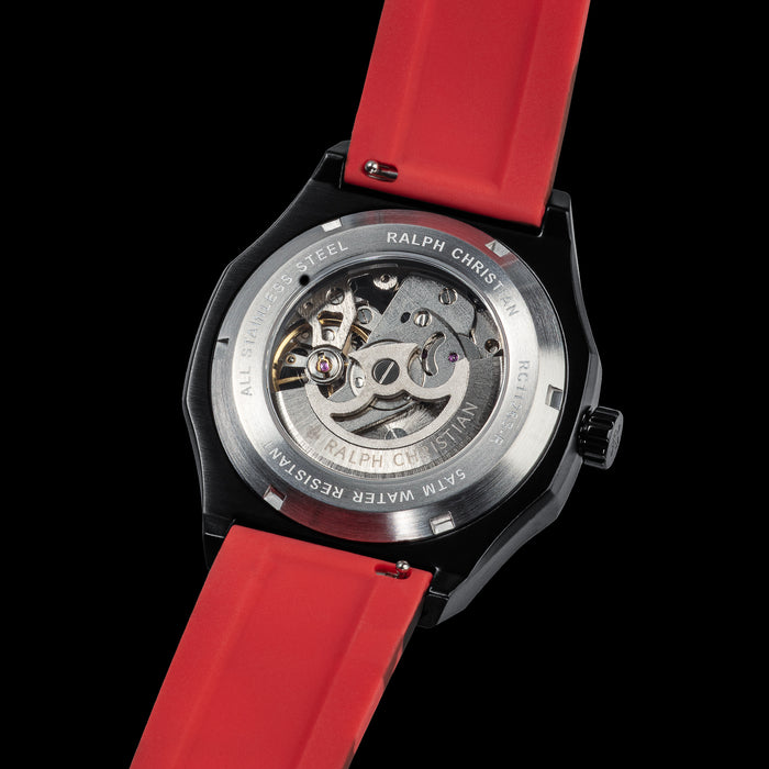 The Maverick STEEL - Camo Red with a black stainless steel case featuring an exhibition case-back revealing intricate watch movement, paired with a bold red strap, bold by design.
