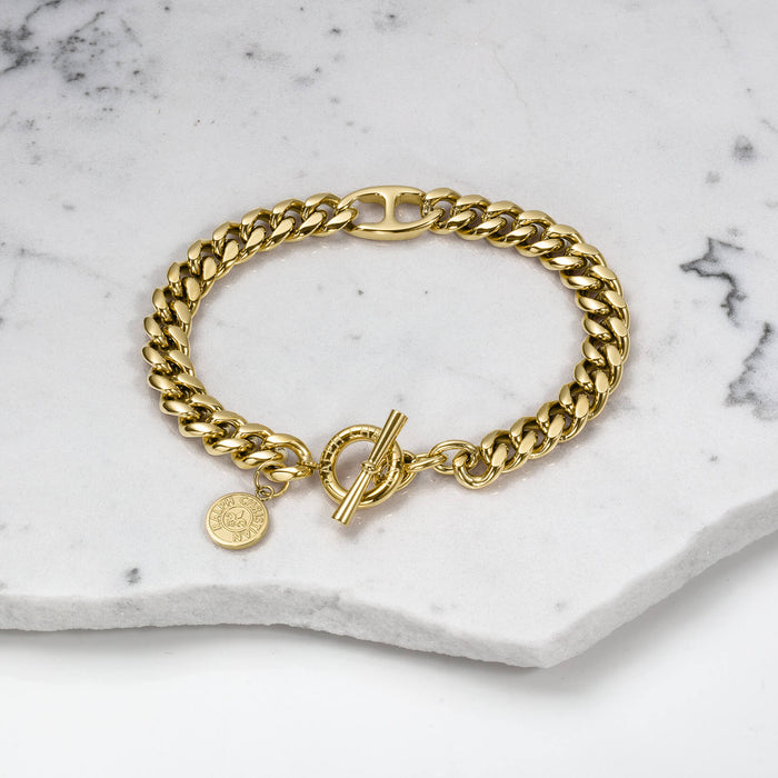 The Medallion Bracelet - Gold featuring a chunky polished gold chain with a toggle clasp and a small round medallion charm, displayed on a white marble surface.