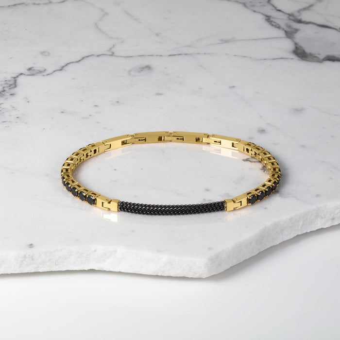 The Midnight Luxe Bracelet featuring a sleek gold-tone chain with a black woven detail centerpiece, designed as a bold statement piece for men.