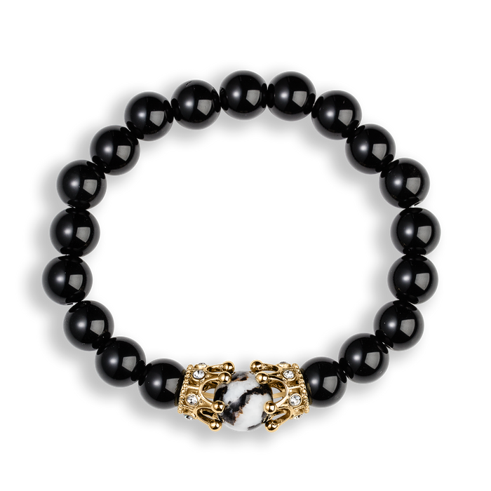 The Royal Obsidian Bracelet featuring polished black beads and a gold crown clasp accented with clear cubic zirconia, designed as bold men's jewelry by Ralph Christian.