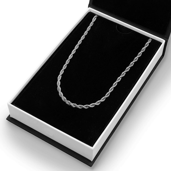 The Silver Rope Necklace - Essentials Collection displayed in an open black and white box, featuring a polished silver twisted rope design for men's jewelry, bold by design.
