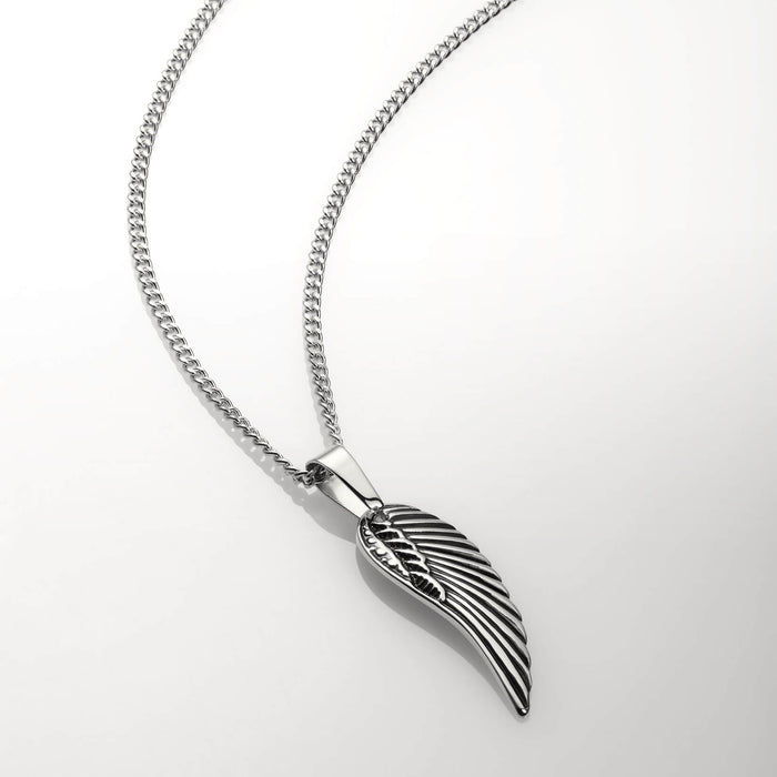 The Silver Wing Pendant - Essentials Collection featuring a sleek, silver wing-shaped pendant with detailed feather engraving, suspended on a polished silver chain, men's jewelry statement piece.