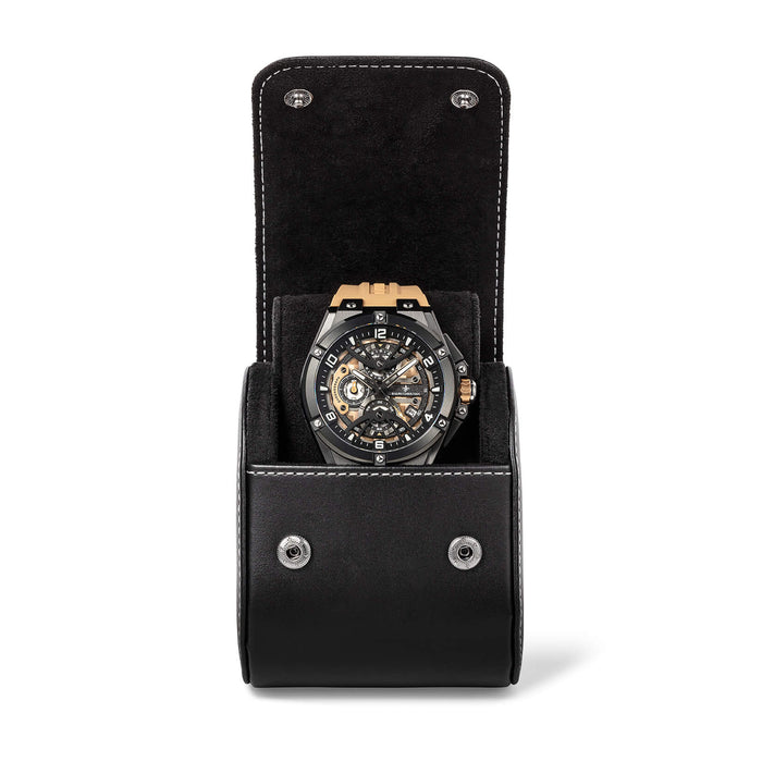 Black leather Watch Case open to display a men's statement watch with gold accents, skeleton dial, and black strap, showcasing bold design and intricate watchmaking details.